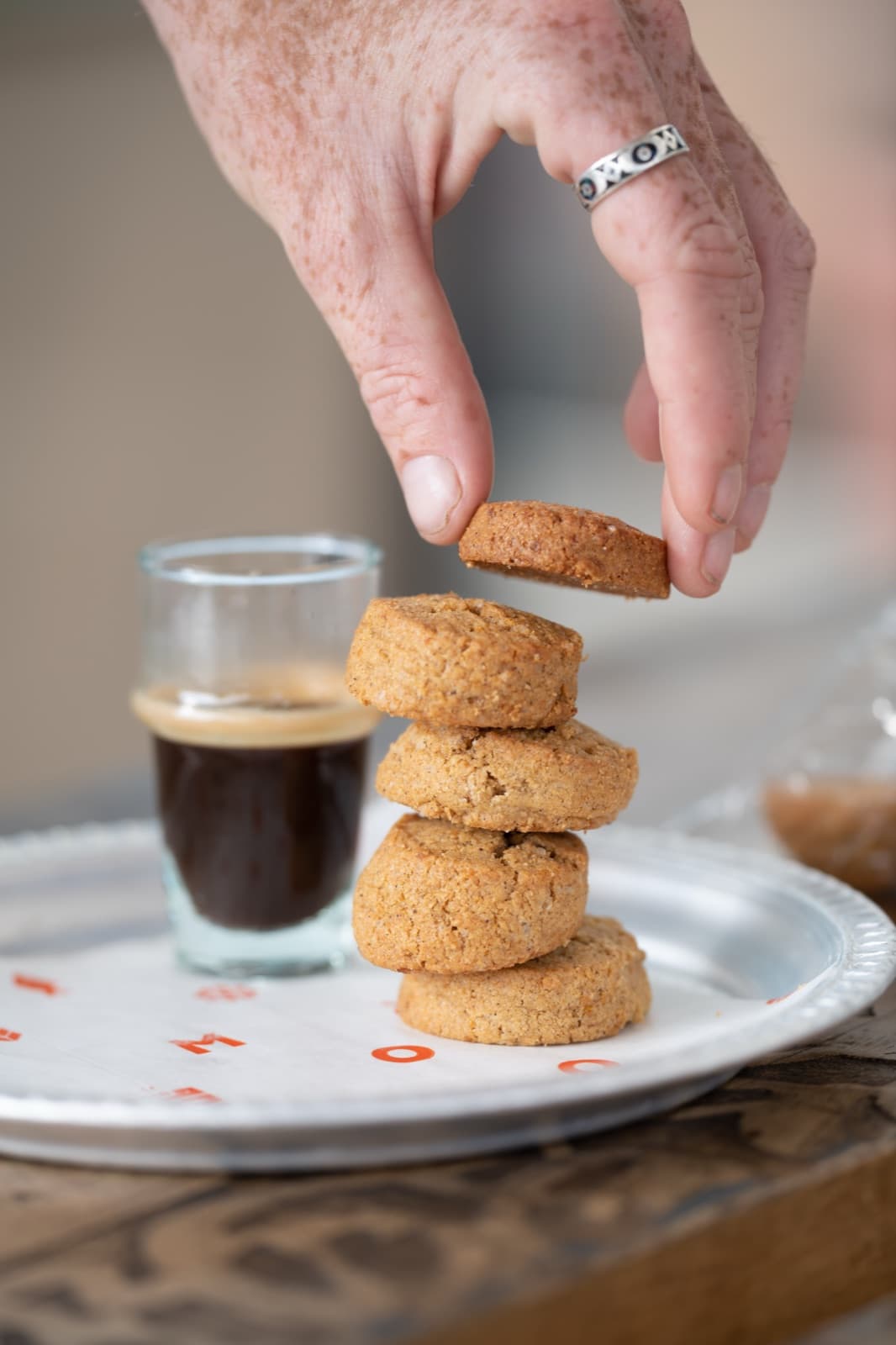 Espresso and stacked Moojood shortbread on a metal tray.